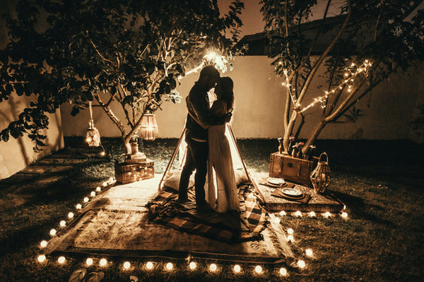 couple dancing under Christmas lights